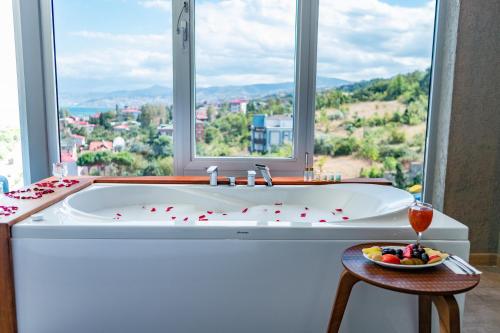 a large bath tub in a bathroom with a window at Tilya Resort Hotel in Trabzon