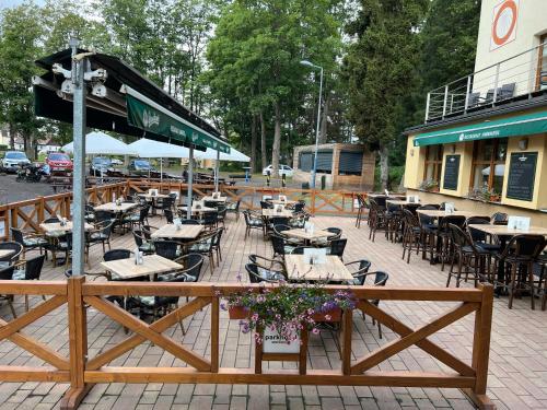 a row of tables and chairs in a restaurant at Parkhotel Smržovka in Smržovka