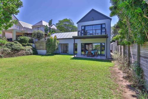 a house with a lawn in front of it at Relaxation in KwaDukuza