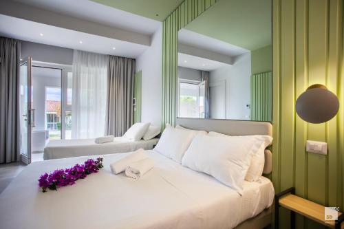 a bedroom with a large bed with purple flowers on it at Villaggio Baia D'Ercole in Capo Vaticano