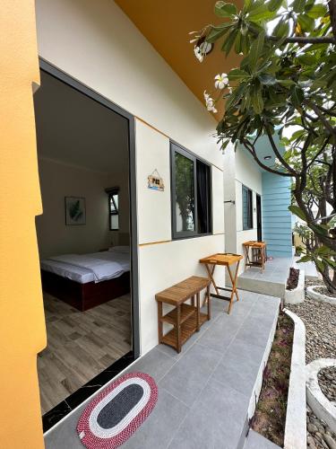 a guest house with a bedroom and a patio at Color Inn - Homestay & Cafe in Ninh Hải