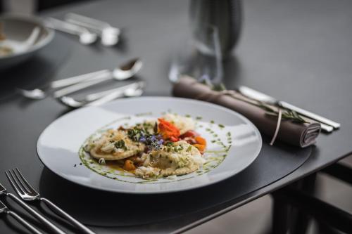 a plate of food sitting on top of a table at Hotel Lanerhof active/spa/balance in San Lorenzo di Sebato