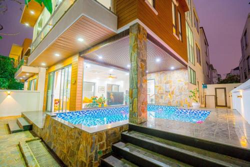 a house with a swimming pool in the backyard at Sea Villa - FLC Sam Son in Sầm Sơn