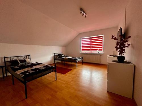 a room with two beds and a window at Boardinghouse Miltenberg in Miltenberg