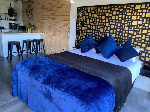 a bedroom with a large blue bed with a bar at Beach House in Yeppoon