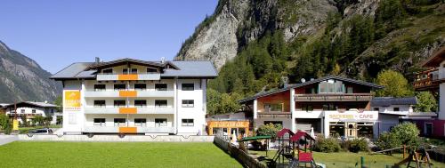 a group of buildings in front of a mountain at Top Tirol Appartement in Längenfeld