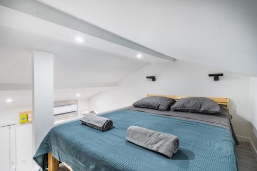 a white room with a bed with two pillows at Bonsai Flat in Beausoleil in Beausoleil