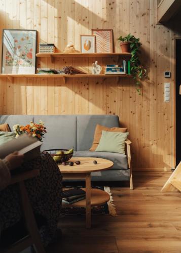 a living room with a couch and a table at Miło las widzieć in Ciwoniuki