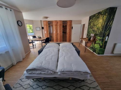 a large white bed in a living room at Ferienwohnung am Radweg in Bad Ems
