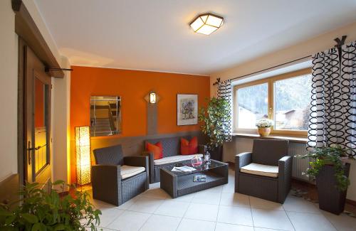 a living room with two chairs and a table at Top Tirol Appartement in Längenfeld