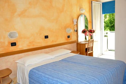 Postel nebo postele na pokoji v ubytování Hotel Abbondanza