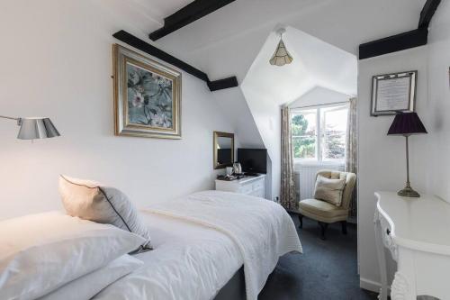 a white bedroom with a bed and a desk at Private Use-Mount Pleasant Hotel 17 BR (sleeps32) in Sidmouth