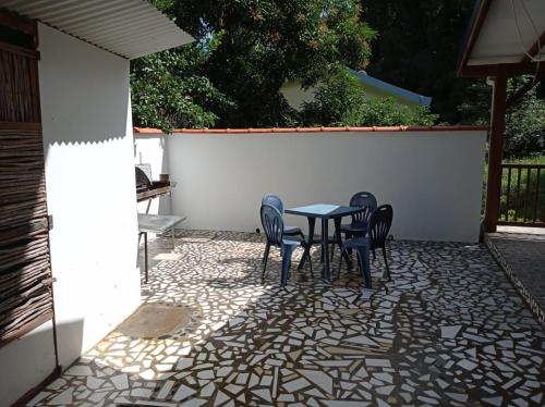 a table and chairs sitting on a patio at L’Habitation BoisNeuf in La Trinité