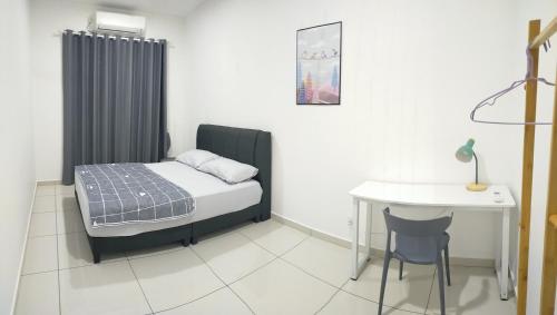 a bedroom with a bed and a desk and a table at Four Leaf Clover Residence @ Crest Mount Austin JB in Johor Bahru