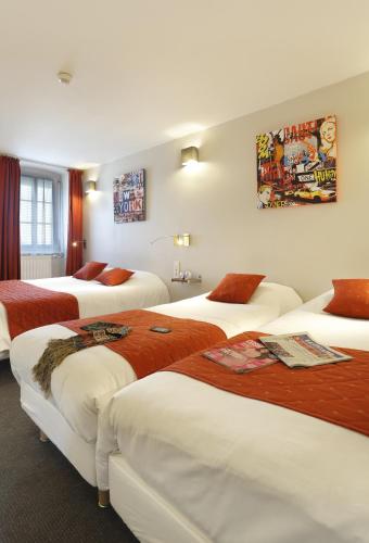 a hotel room with four beds in it at Hôtel Les Tilleuls, Bourges in Bourges