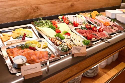 a buffet line with many different types of food at Hotel Rittergut Stoermede in Geseke