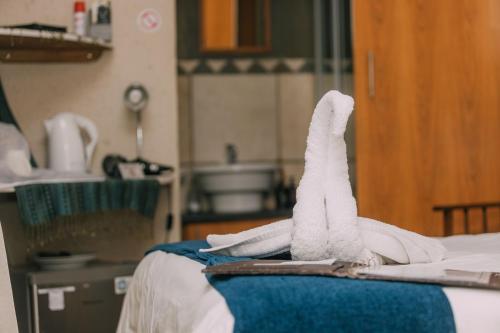 a hospital room with towels on a bed at Beetleloop Guest House in Nelspruit
