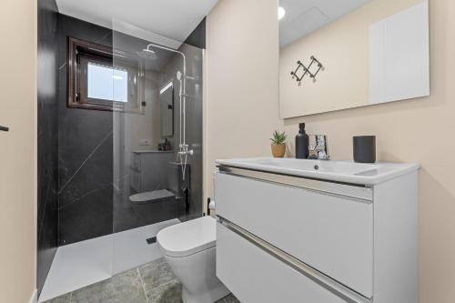 a bathroom with a toilet and a sink and a shower at Casa Aldea in Puerto del Carmen