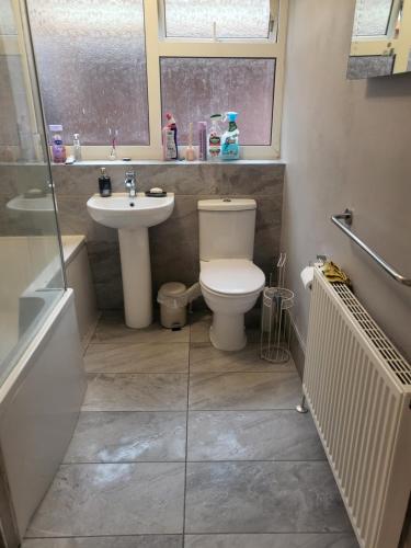a bathroom with a toilet and a sink at THE NEST in Nottingham