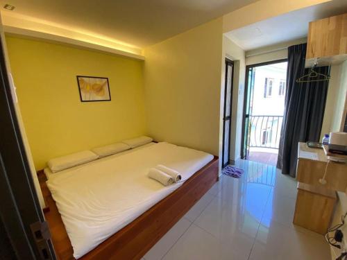 a bedroom with a bed with two towels on it at HOTEL ADAM FALIQ in Brinchang