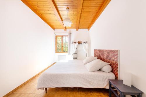 ein Schlafzimmer mit einem Bett und einer Ziegelwand in der Unterkunft L'Oustaou Dou Verdoun - Avec grand jardin in Régusse