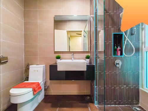 a bathroom with a sink and a toilet and a mirror at Medini Signature Ninjago Suites in Nusajaya