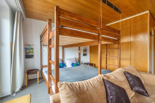 a bedroom with a bunk bed and a couch at Apartment Grundblick in Bad Grund
