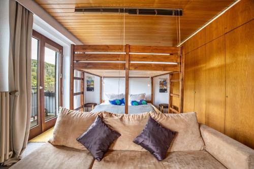 a bedroom with a large bed with wooden walls at Apartment Grundblick in Bad Grund