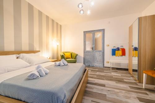 a bedroom with a bed with towels on it at BeB Omare Agrigento in Agrigento