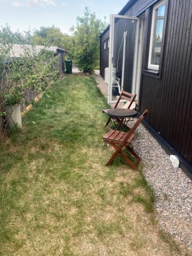 a picnic table and two benches next to a building at Stockholms home away from home in Stockholm