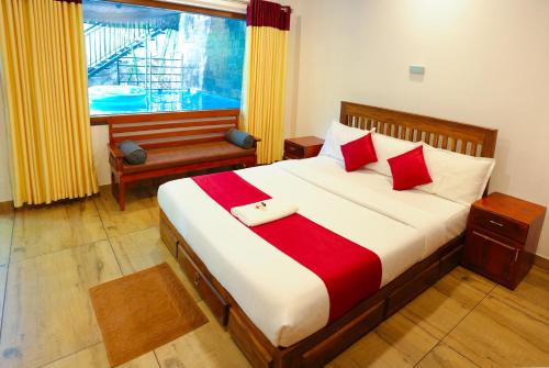 a bedroom with a large bed and a window at Agasthya Private Pool & Park villa in Sultan Bathery