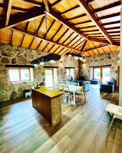a large room with tables and chairs in a building at Casa de Pelicas - Celorico de Basto in Celorico de Basto