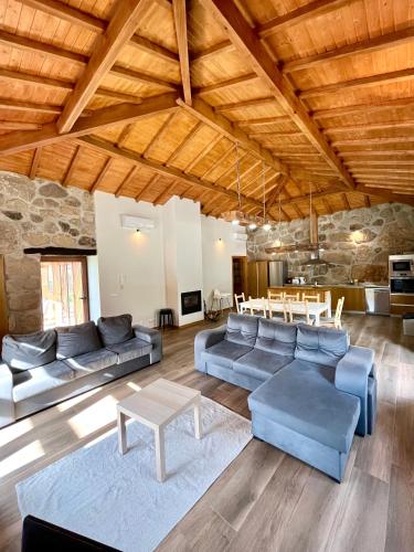 a living room with blue couches and a table at Casa de Pelicas - Celorico de Basto in Celorico de Basto