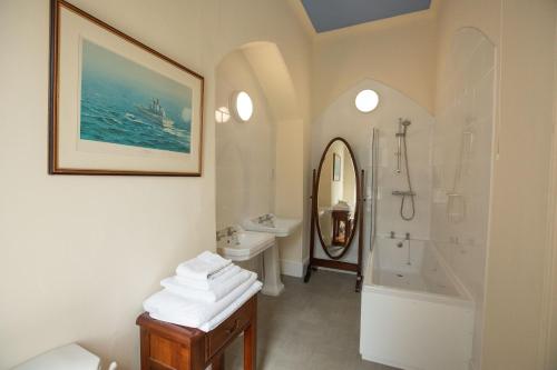 a bathroom with a sink and a tub and a shower at Grafton Manor Hotel in Bromsgrove