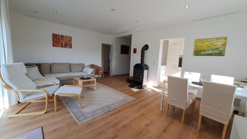 a living room with a couch and a table with chairs at Haus Sonnenburg in Dahlem