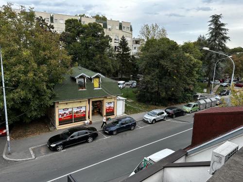 a street with cars parked on the side of a road at Cozy loft in Belgrade