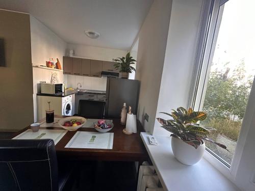 a small kitchen with a table and a window at Comfy apartment in the center in Chişinău