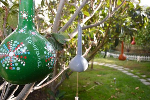 a green glass ornament hanging from a tree at Panorama Zimmer und Apartments Lentas in Léntas