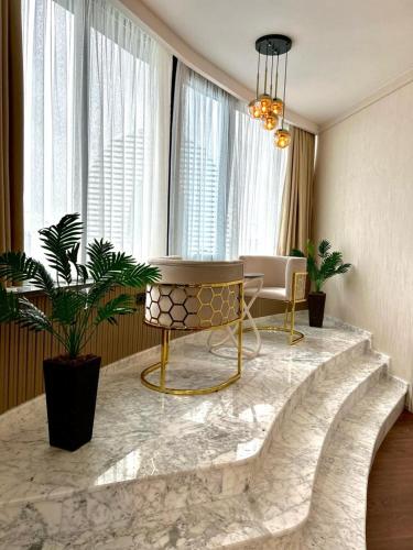 a living room with a couch and a table at King Sky Tower Hotel in Batumi