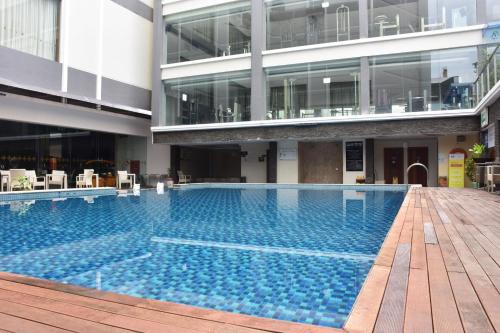 a large swimming pool in the middle of a building at Sahid Batam Center Hotel and Convention in Batam Center