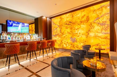 a bar with chairs and a large wall mural at BOULEVARD Boutique Studios in Lisbon