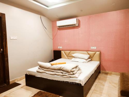 a small room with a bed with a heater at Hotel Bhagwani Palace in Jorhāt