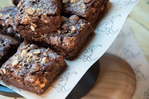 a pile of chocolate brownies on a plate at 31A Urban Stays in Norwich