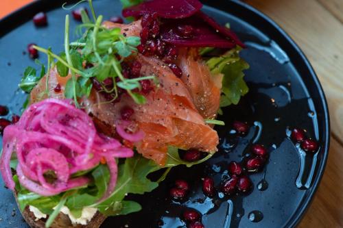 a blue plate of food with a salad and meat at 31A Urban Stays in Norwich