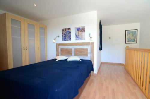 - une chambre avec un lit bleu et 2 oreillers dans l'établissement PINIMAR B 3-4, à L'Estartit