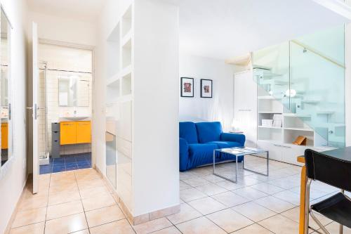 a living room with a blue couch and a staircase at Venezia Double in Florence