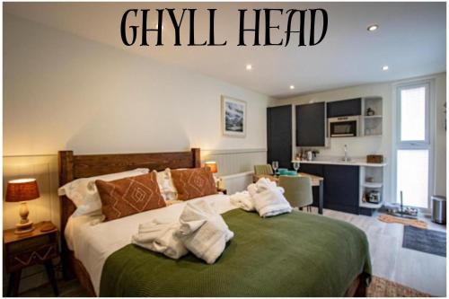 a bedroom with a bed with towels on it at Lake District Woodland Pods - Winster, Bowness-on-Windermere in Winster