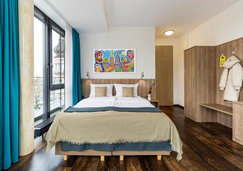 a bedroom with a large bed and a large window at KONCEPT HOTEL Benedikt in Siegburg
