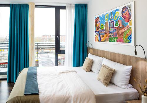 a bedroom with a bed and a large window at KONCEPT HOTEL Benedikt in Siegburg