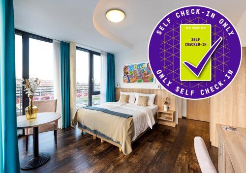 a bedroom with a bed and a purple clock on the wall at KONCEPT HOTEL Benedikt in Siegburg